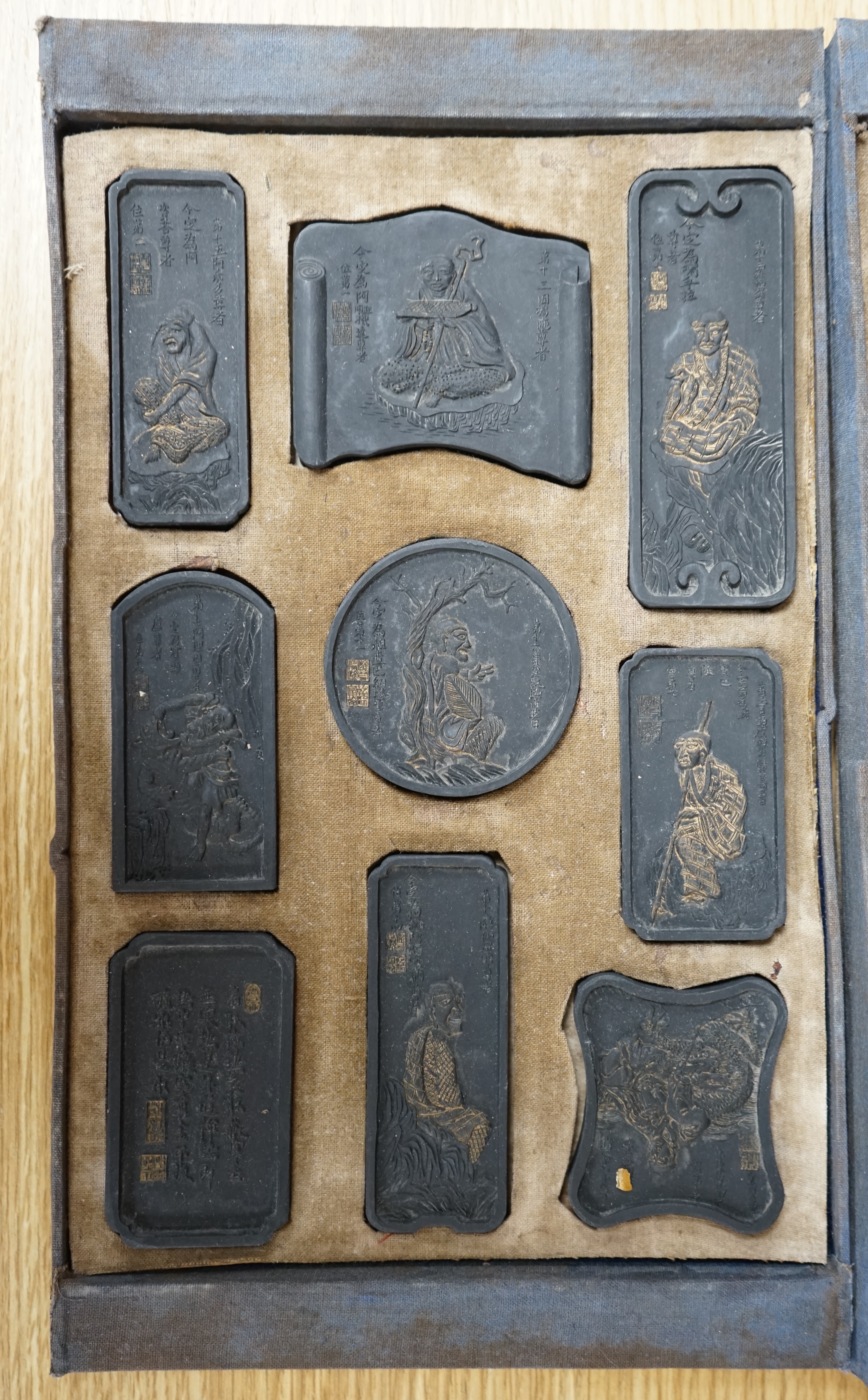 A boxed set of carved Chinese ink stones. Condition - worn